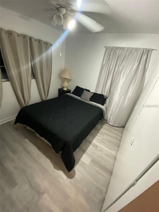 bedroom featuring light wood-type flooring and ceiling fan