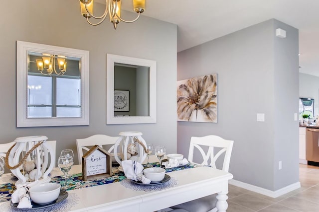 dining space with light tile patterned flooring and an inviting chandelier