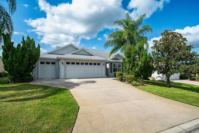 view of front of house with a front lawn and a garage