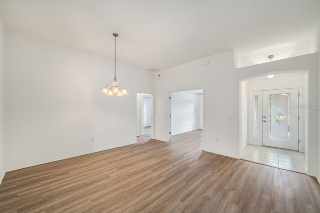 interior space with an inviting chandelier and hardwood / wood-style floors