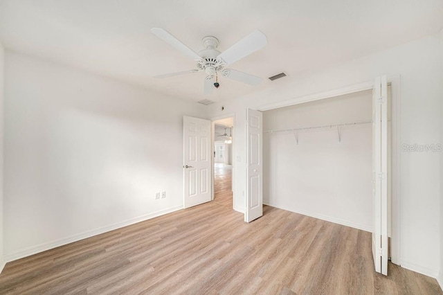 unfurnished bedroom featuring a closet, light wood-type flooring, and ceiling fan