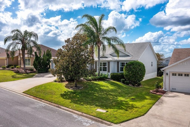 view of front of house with a front yard and a garage