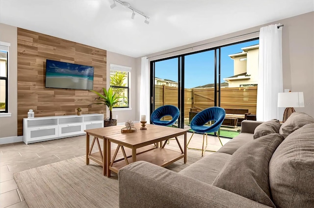 living room with wooden walls and rail lighting