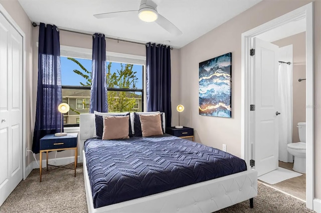 carpeted bedroom featuring ensuite bathroom and ceiling fan