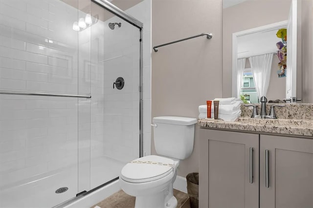 bathroom with vanity, toilet, and walk in shower