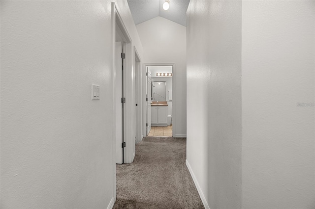 1029 Park Ridge Cir, Kissimmee, FL 34746 - hallway with carpet flooring, baseboards, and lofted ceiling