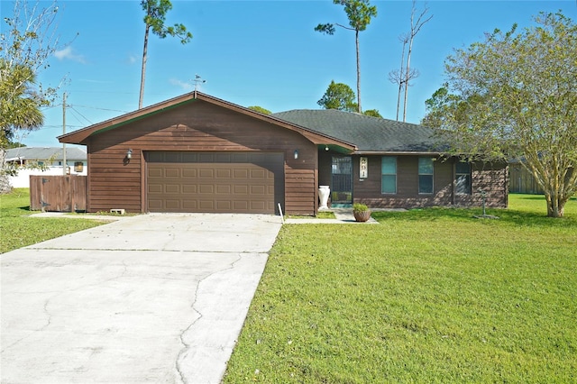 ranch-style house featuring a front lawn and a garage