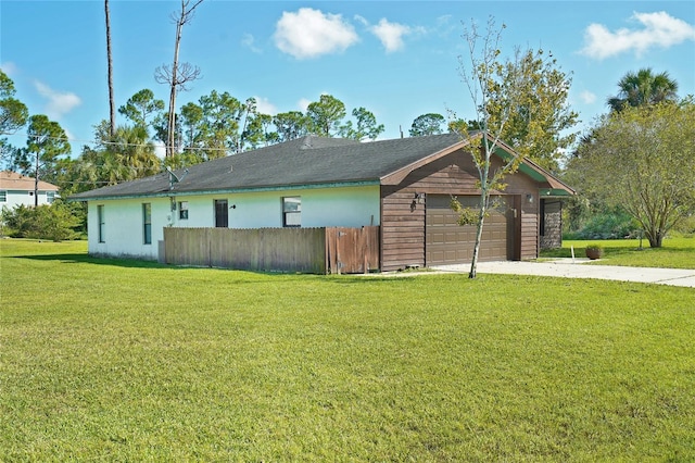 view of property exterior featuring a lawn and a garage