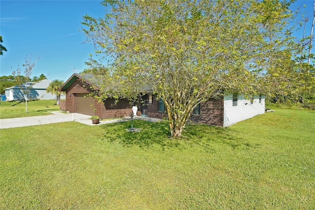 obstructed view of property with a garage and a front lawn