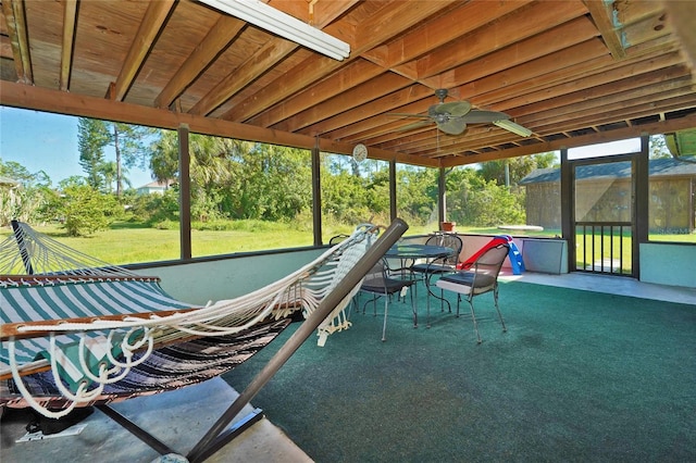 unfurnished sunroom with ceiling fan and a healthy amount of sunlight