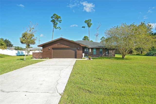 ranch-style house featuring a front yard and a garage