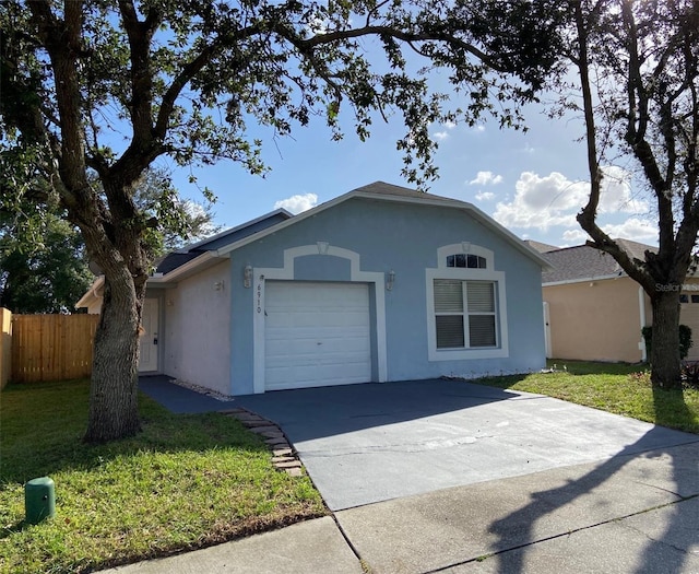 view of front of home featuring a front yard and a garage