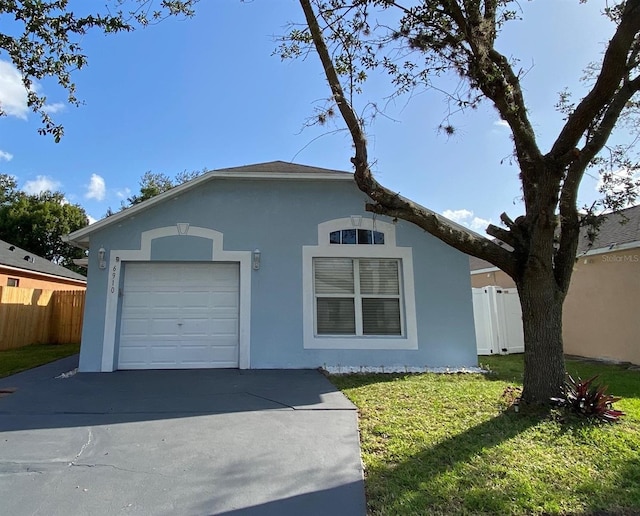 single story home with a front yard and a garage