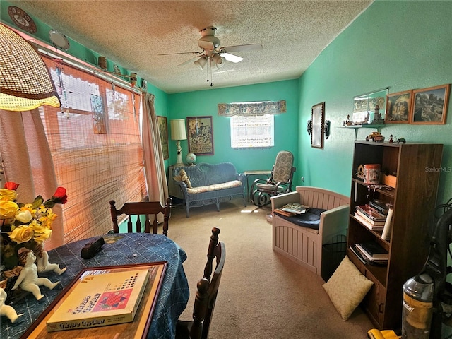 bedroom featuring ceiling fan, a textured ceiling, and carpet floors