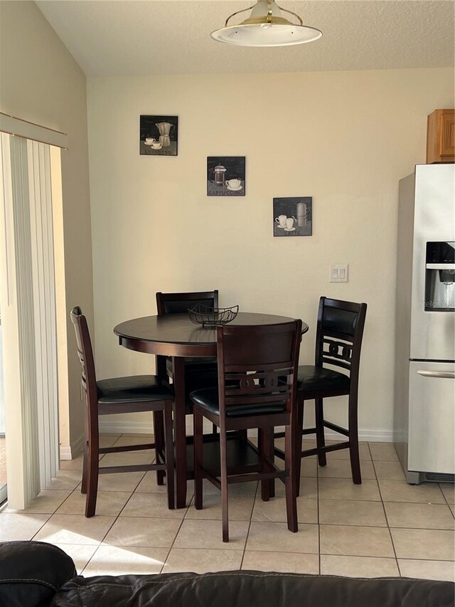 dining area featuring light tile patterned floors