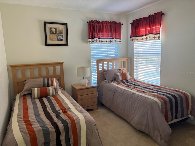 bedroom featuring light colored carpet