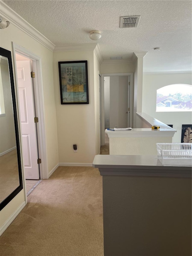 corridor featuring crown molding, visible vents, light carpet, baseboards, and a textured ceiling