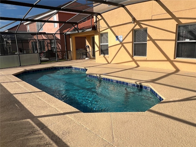 pool with a lanai and a patio