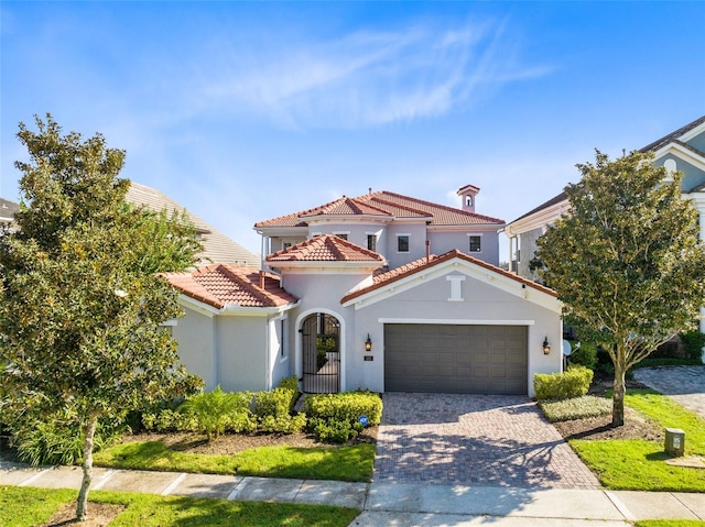 mediterranean / spanish house with a garage