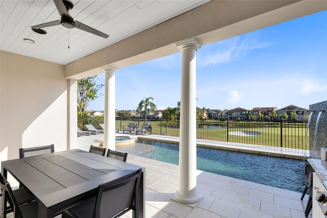 view of swimming pool featuring a patio area, a lawn, a water view, and ceiling fan