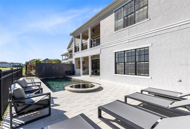 view of patio / terrace with a balcony, pool water feature, and a fenced in pool