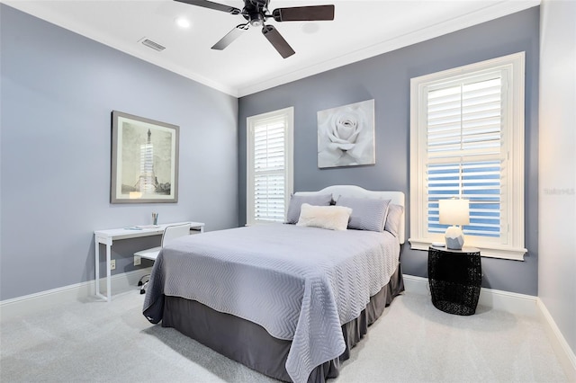 carpeted bedroom featuring ceiling fan and ornamental molding