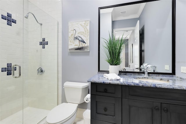 bathroom featuring toilet, a shower with shower door, vanity, and crown molding