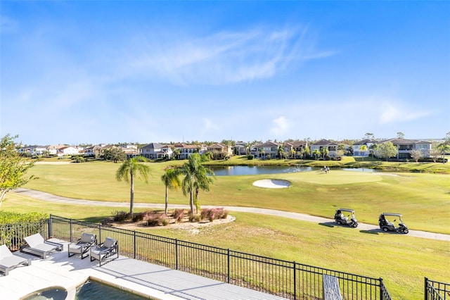 view of property's community featuring a patio area, a lawn, and a water view