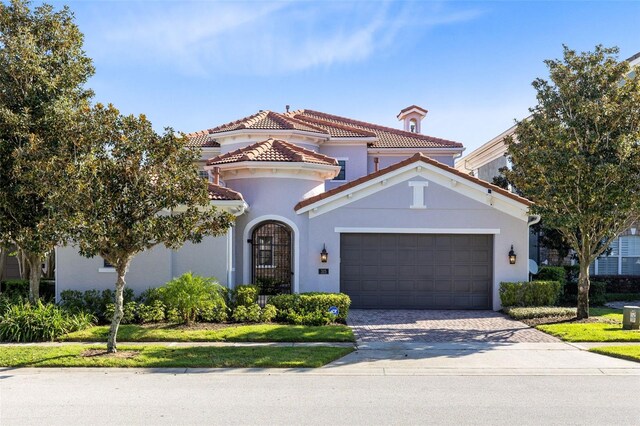 mediterranean / spanish house with a garage