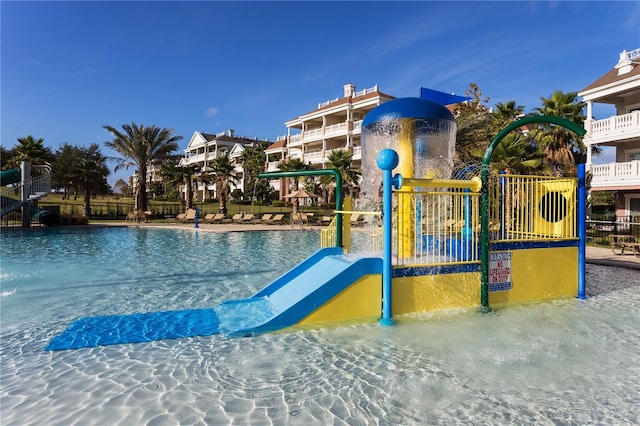 view of swimming pool featuring a playground