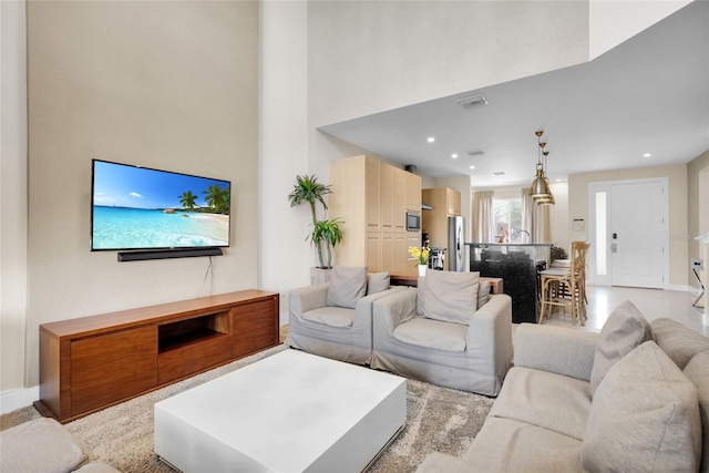 living room featuring a towering ceiling