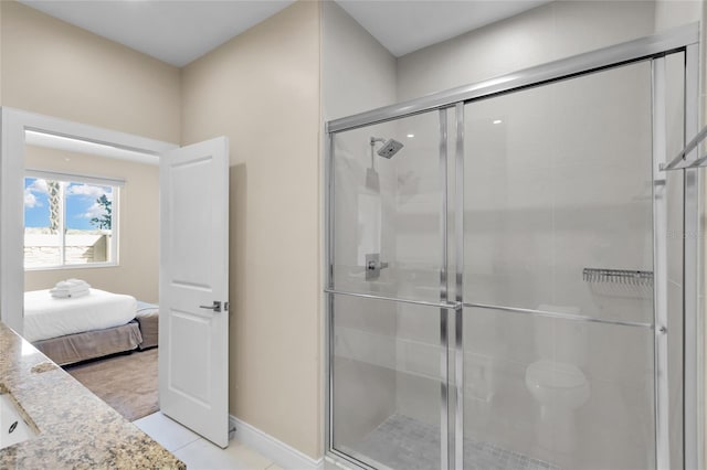 bathroom with a shower with shower door and tile patterned floors