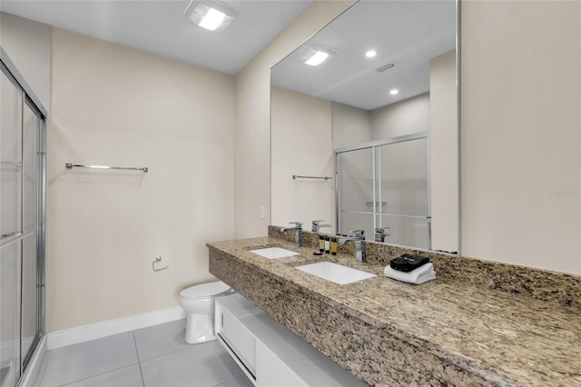 bathroom featuring toilet, an enclosed shower, vanity, and tile patterned floors