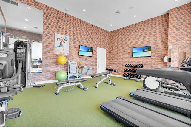 gym with brick wall and carpet flooring