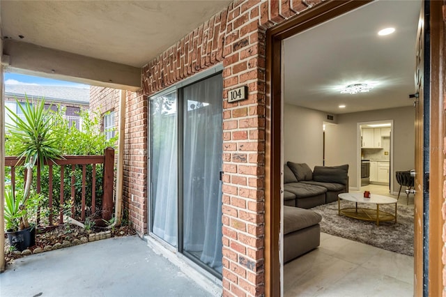 doorway to property with brick siding