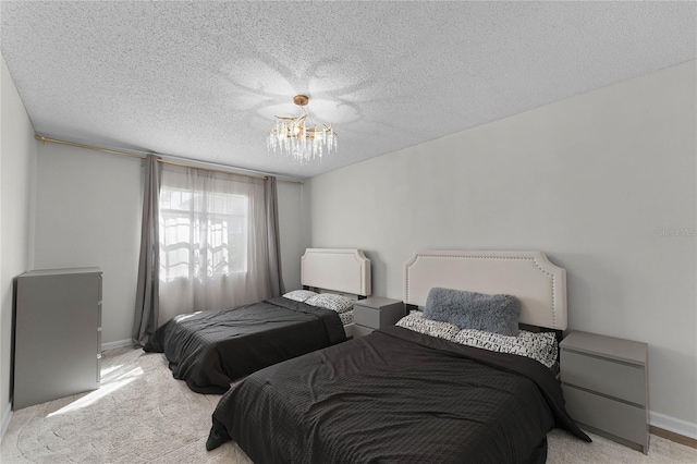 carpeted bedroom featuring a textured ceiling and an inviting chandelier