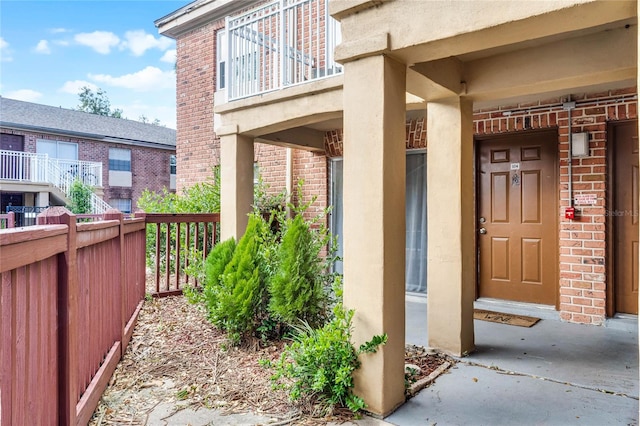 view of exterior entry featuring a balcony