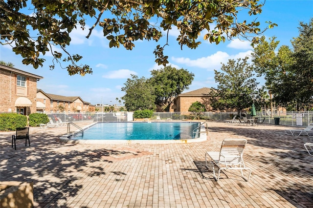 view of swimming pool featuring a patio area