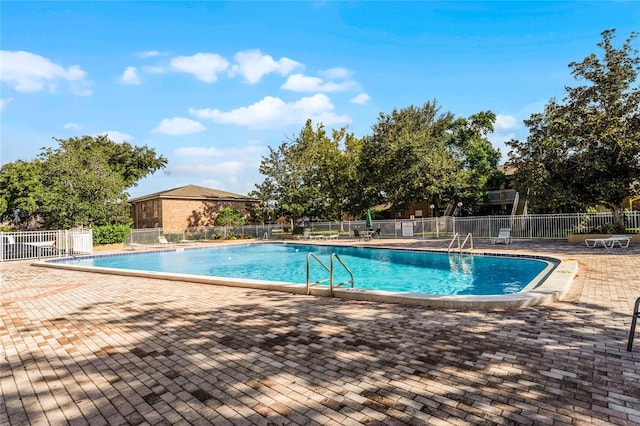 view of swimming pool with a patio