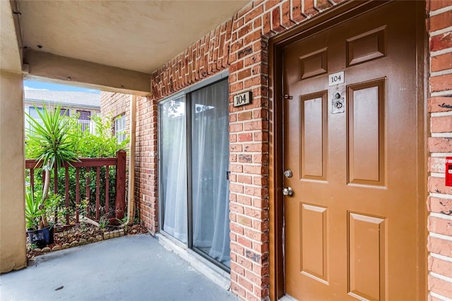 property entrance featuring brick siding