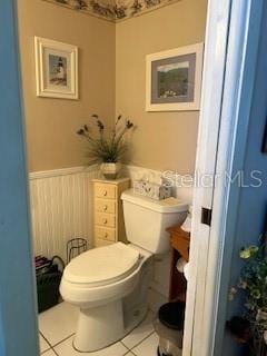 bathroom with toilet and tile patterned floors