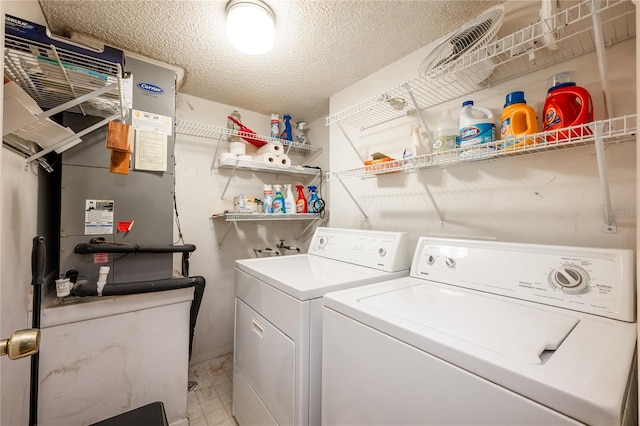 washroom with washing machine and dryer and a textured ceiling