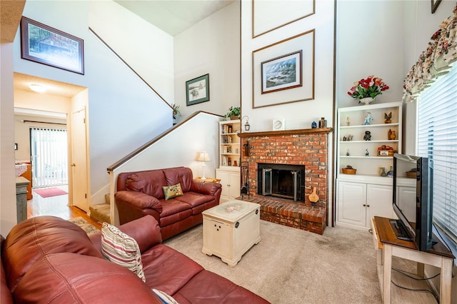 living room featuring light colored carpet and a brick fireplace