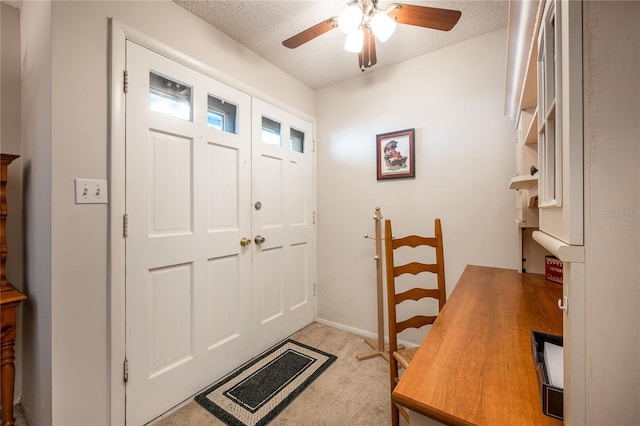 foyer entrance with light carpet, a textured ceiling, and ceiling fan