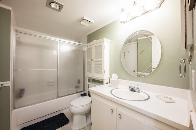 full bathroom featuring toilet, tile patterned flooring, vanity, and combined bath / shower with glass door