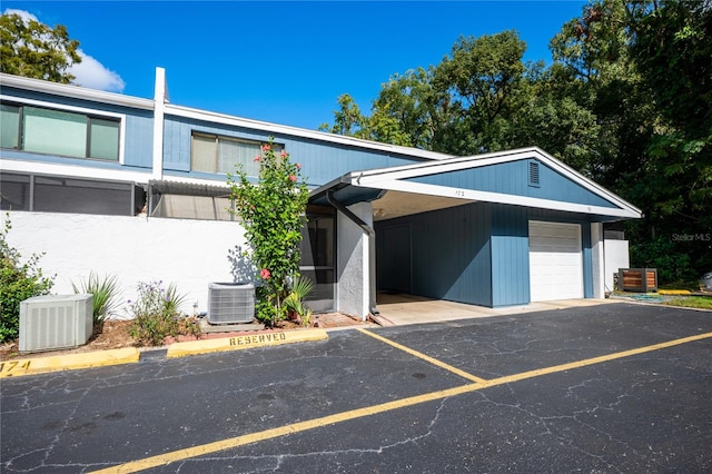 view of front of property with central AC and a garage