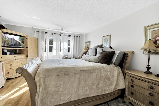 bedroom featuring a textured ceiling and hardwood / wood-style flooring