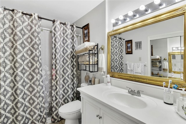 bathroom featuring vanity, toilet, and a shower with curtain