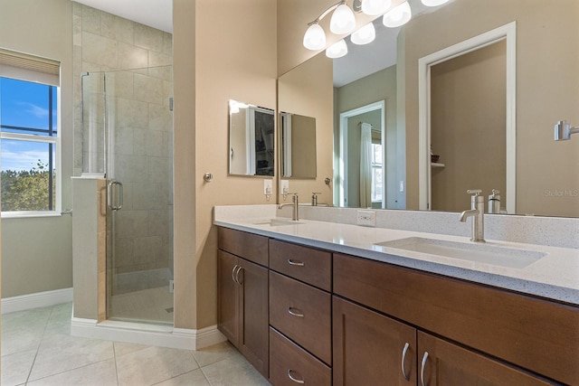 bathroom with tile patterned floors, vanity, and an enclosed shower