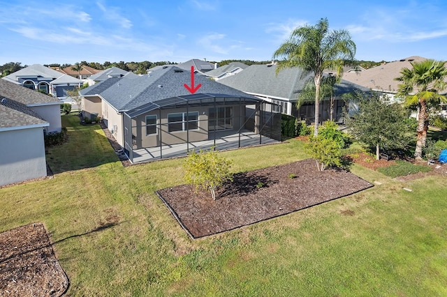 rear view of property featuring a patio, a yard, and glass enclosure